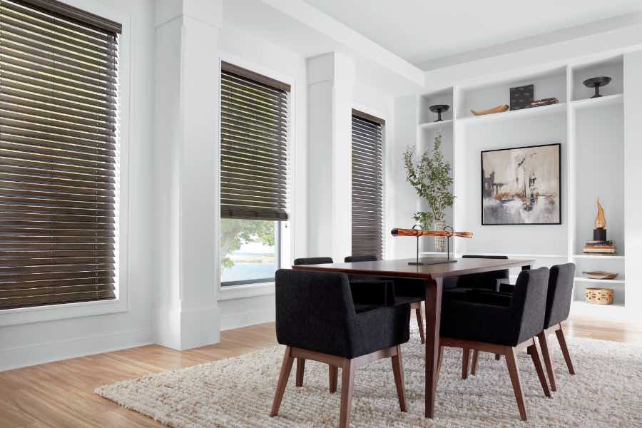 Brown faux wood blinds in a white dining room